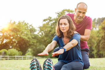 Wall Mural - Couple stretching at park