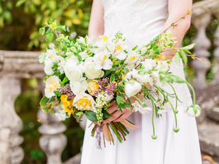 Wedding day. Bride in white dress with wedding bouquet.