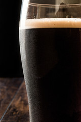 Poster - Dark Beer on wooden surface. Close up view.