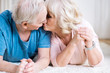 © LIGHTFIELD STUDIOS - Beautiful senior couple lying on carpet together and kissing