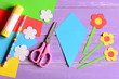 Creating paper crafts for mother's day or birthday. Step. Guide. Details to making a paper bouquet for mommy. Scissors, glue stick, flowers templates, pencil on a table. Kids art activity. Top view