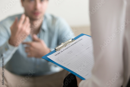 Fotografía Young man consulting with medical doctor or psychologist, complaining about health, having problems