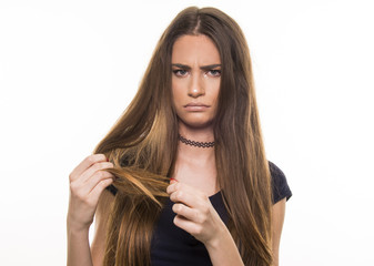  beautiful girl supprised and unhappy with her damaged and dry hair