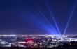 © tannujannu - Huge spotlight rays over the night panorama of Los Angeles city