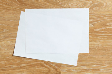 Blank sheet of paper on wooden background