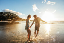 Beautiful Young Couple Having Fun On Beach