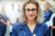 © Flamingo Images - Blonde female medic in hospital looking at camera