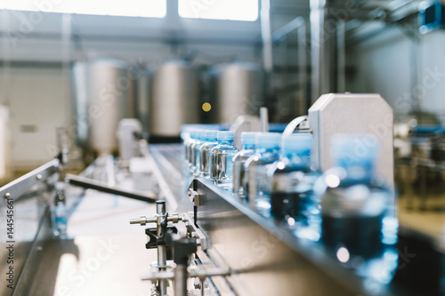 Water factory - Water bottling line for processing and bottling pure spring water into small blue bottles Canvas Print