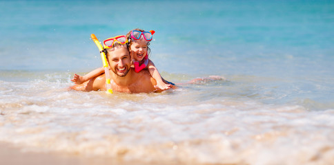 Canvas Print - Happy family father and child wearing mask and laughing  on beach