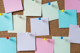 Fototapeta  - colorful sticky notes on cork bulletin board