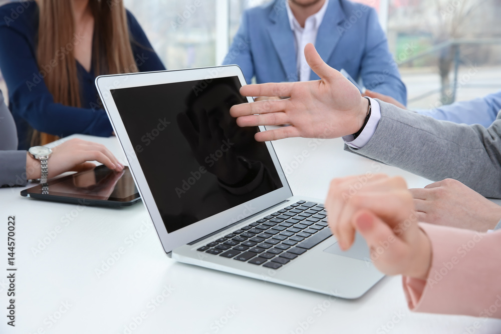 Team work concept. People sitting at table in office and using laptop