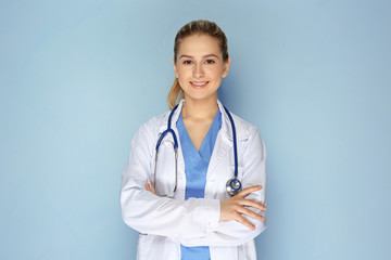 Female doctor with stethoscope on color background