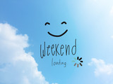 Fototapeta  - Weekend loading word and smile face on blue sky