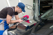 © zhekkka - A man polishes a black car