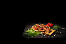 Fresh Tasty Pizza On Black Background On Rustic Wooden Table With Ingredients. Italian Food.