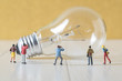 miniature photographer take a picture of vintage light bulb