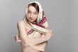 Studio portrait of cute pretty girl in a russian kerchief, topless.