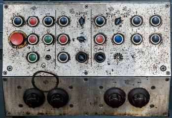 Details of a control desk, old and dirty, part of a machine.