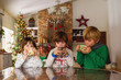 © RooM The Agency - Three children drinking hot chocolate at Christmas