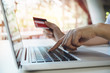 © successphoto - asian young woman hands holding credit card and using laptop smart phone Online shopping.Online shopping concept