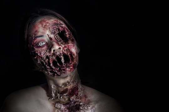 horrible scary zombie girl on black background with copyspace