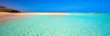 Island With Sandy Beach, Green Lagoon And Clear Water, Fuerteventura, Canary Island, Spain.
