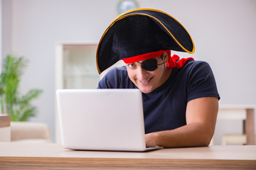 digital security concept with pirate at computer