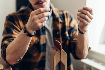 Man working with leather using crafting DIY tools