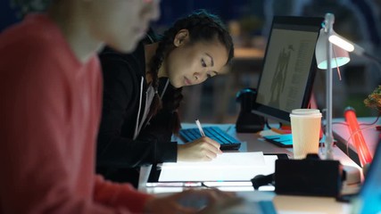  Young computer game designer drawing & working on computer