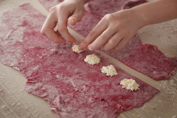 Canvas Print - Woman making ravioli on table