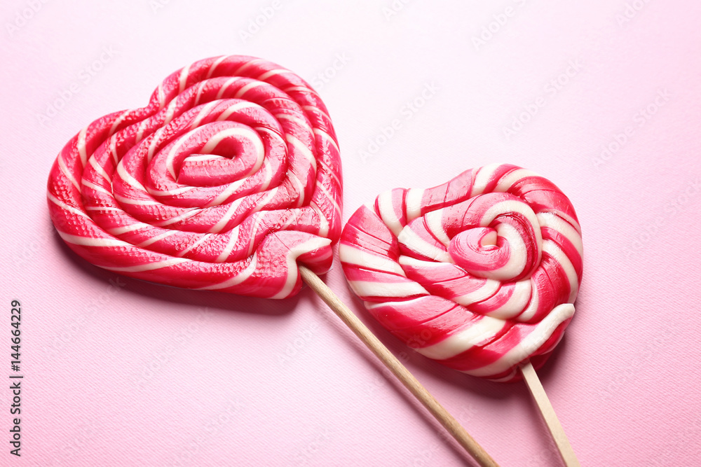 Tasty lollipops on color background, closeup