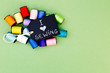 I love Sewing - with blackboard and colorful cotton thread reels on green cardboard background
