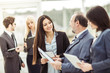 © yurolaitsalbert - successful businessman and business team discussing business documents standing in the lobby of the office