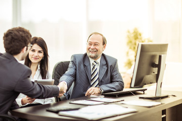 handshake business partners after discussion of the financial terms of the new contract