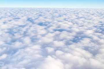 Wall Mural - blue sky and cloud top view from airplane window,nature background