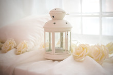White Lantern For Candle And White Roses. Closed Lantern For Candle At Wooden Box On Wedding Reception. Wedding Stage Decoration. Wedding Style Lantern Vintage Lantern. 
