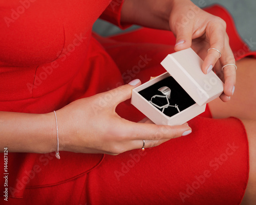 Zdjęcie XXL Piękna srebna biżuteria w pudełku, kobiet ręki pokazuje, zakończenie. Akcesoria dla modnych pań