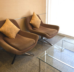 Two brown armchair in living room.