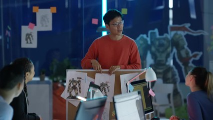  Young Asian video game designers in a team meeting