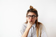 © shurkin_son - Close up portrait of funny confused woman in glasses thinking and looking aside standing on white wall background. Copy space on the side. Human expressions, emotions, feelings, body language