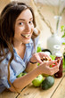 © rh2010 - Closeup view from above of a woman eating brasil nuts with healthy food on the background