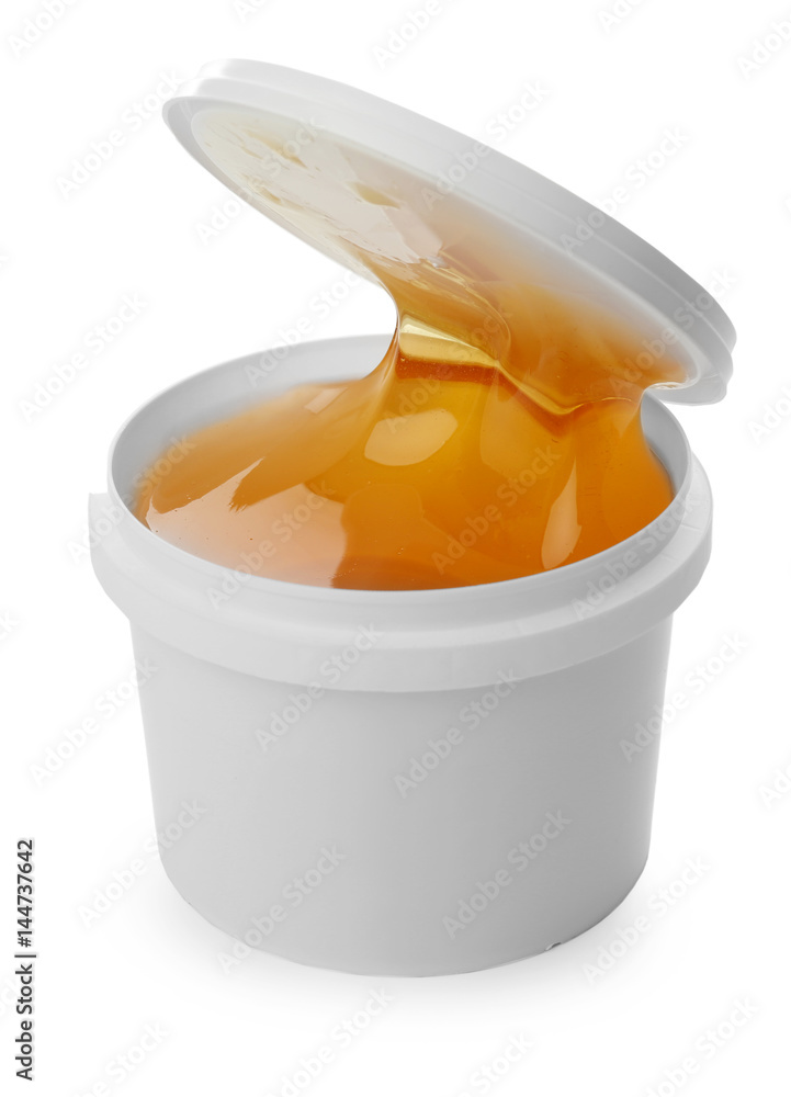 Plastic bucket with sugaring paste on white background