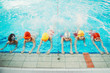 canvas print picture - happy children kids group at swimming pool class learning to swim