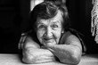© De Visu - Portrait close-up of a happy elderly woman. Black and white photo.