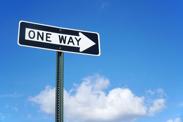 one way sign in front of blue sky and white cloud