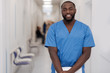 © zinkevych - Young African American man standing and smiling in the hospital
