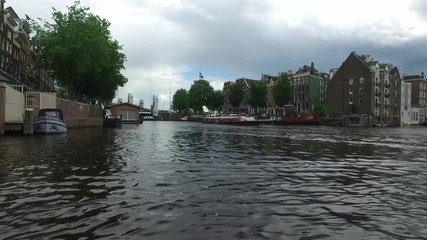 Sticker - AMSTERDAM, NETHERLANDS - JULY 2, 2016 : View from tours with sailboats in canals on cloudy sky. Amsterdam is popular with canal tours.