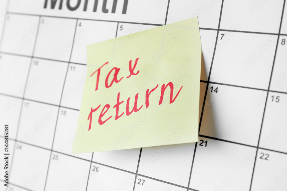 Note with text and calendar. Tax return concept