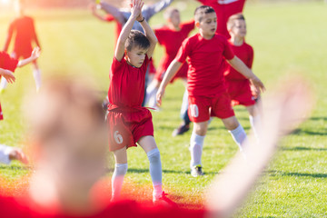 Wall Mural - Kids soccer football - children players exercising before match on soccer field