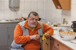 © Yuri Kravchenko - Portrait of bearded senior man working in kitchen